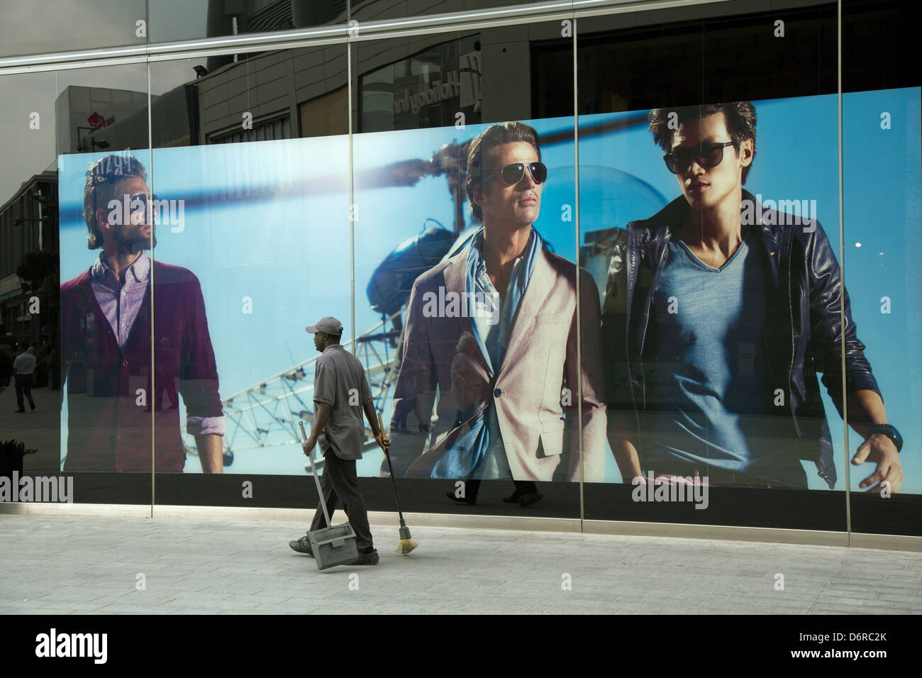 London, United Kingdom, Cleaner before the Boss Store (Hugo Boss) in the  shopping mall Westfield Startford City Stock Photo - Alamy