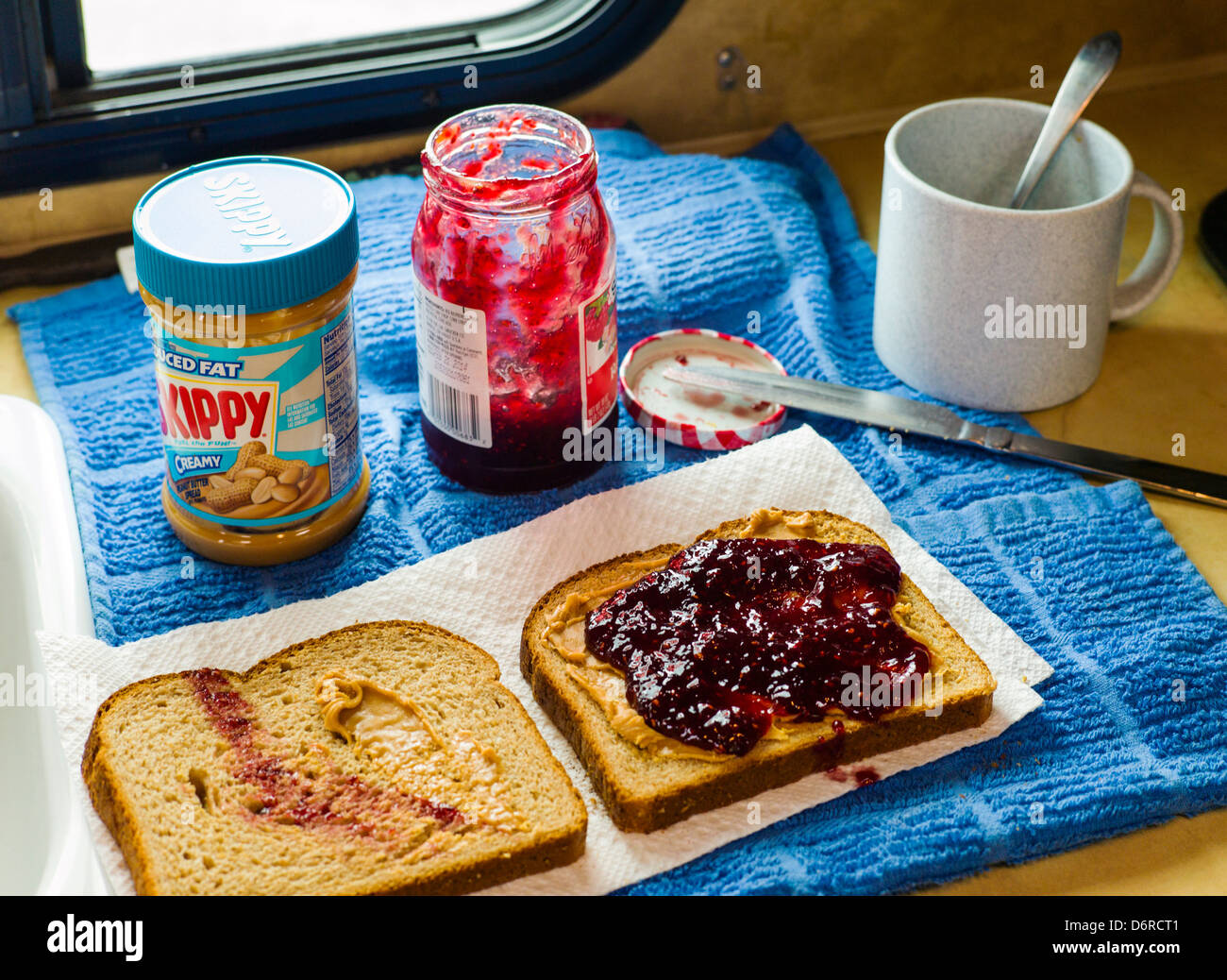 Peanut butter and jelly sandwich and hot coffee inside a camper, Denali