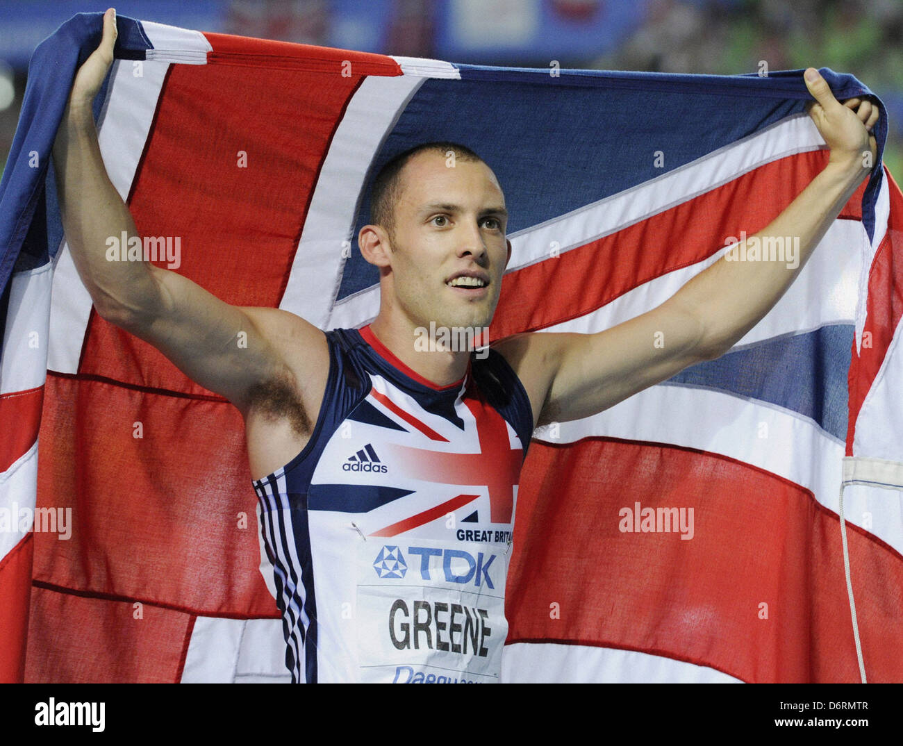 David Greene of Britain runs a victory lap carrying the Union Jack