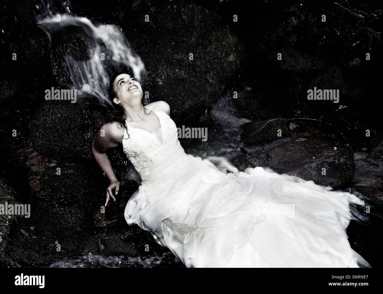 Bride and groom dating close to a waterfall Stock Photo