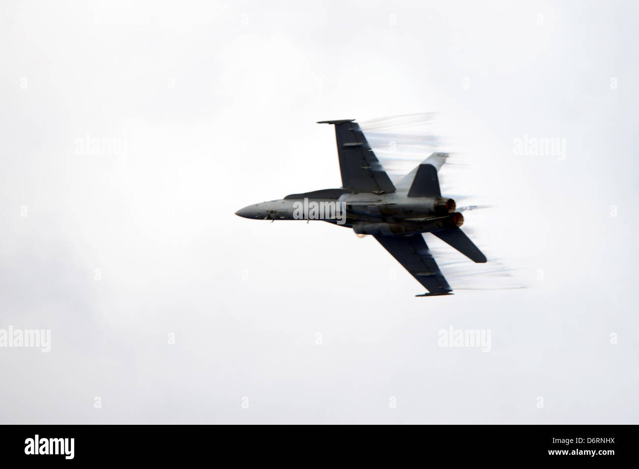 US Navy F/A-18C Hornet aircraft from the aircraft carrier USS John C. Stennis perform a high speed fly by April 23, 2013 in the Pacific Ocean. Stock Photo