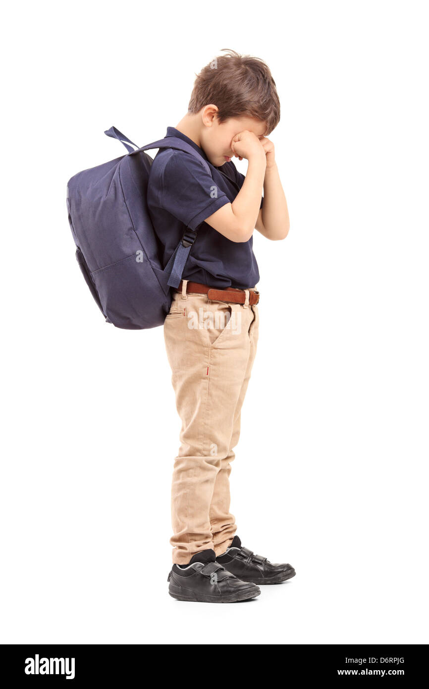 Full length portrait of a schoolboy crying, isolated on white background Stock Photo