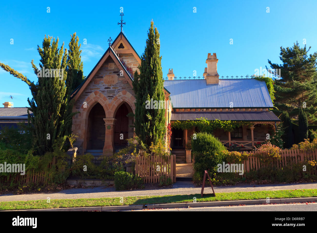 footpath old heritage church buildings main street Clarendon Adelaide Hills South Australia autumn leaves Stock Photo