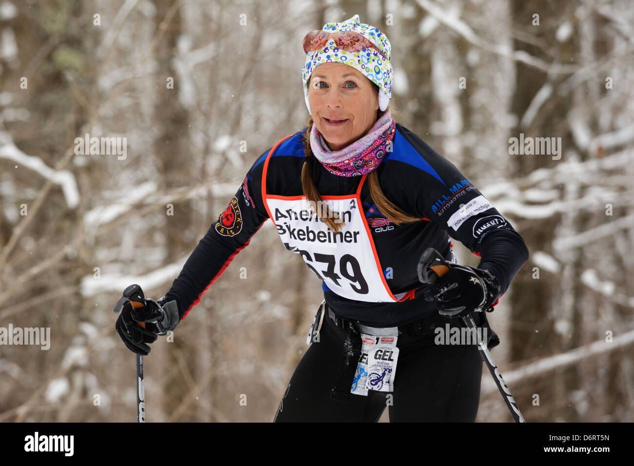 A woman skis on the trail between Cable and Hayward, Wisconsin in the American Birkebeiner on February 23, 2013. Stock Photo