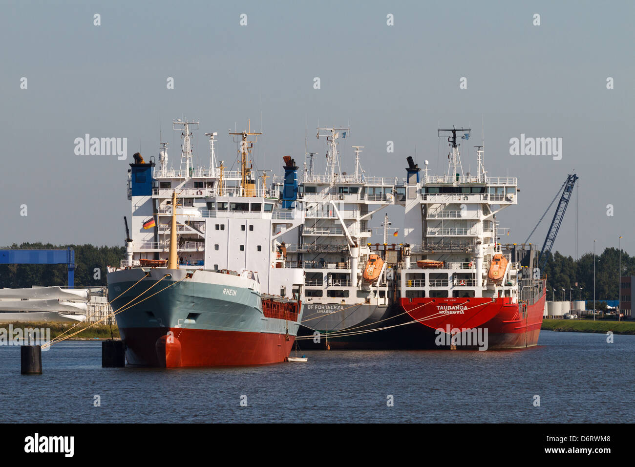 Emden, Germany, four container ships lie at anchor in the inner harbor of Emden Stock Photo