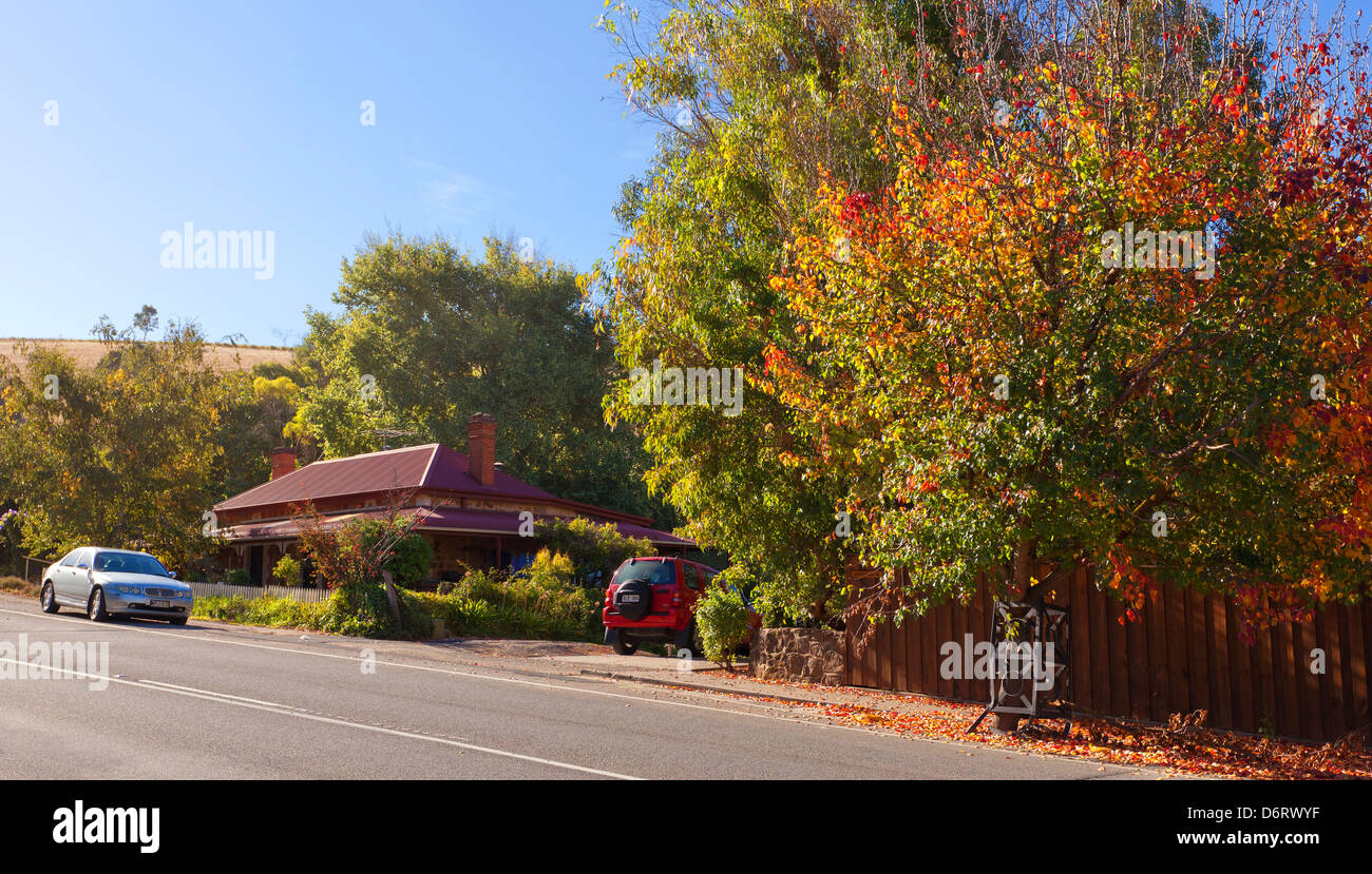 house front green fence old cottage gate footpath main street Clarendon Adelaide Hills South Australia autumn leaves Stock Photo