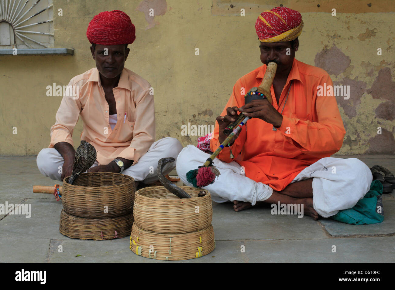Two Snake Charmers inside the pink palace in Jaipur India. Stock Photo