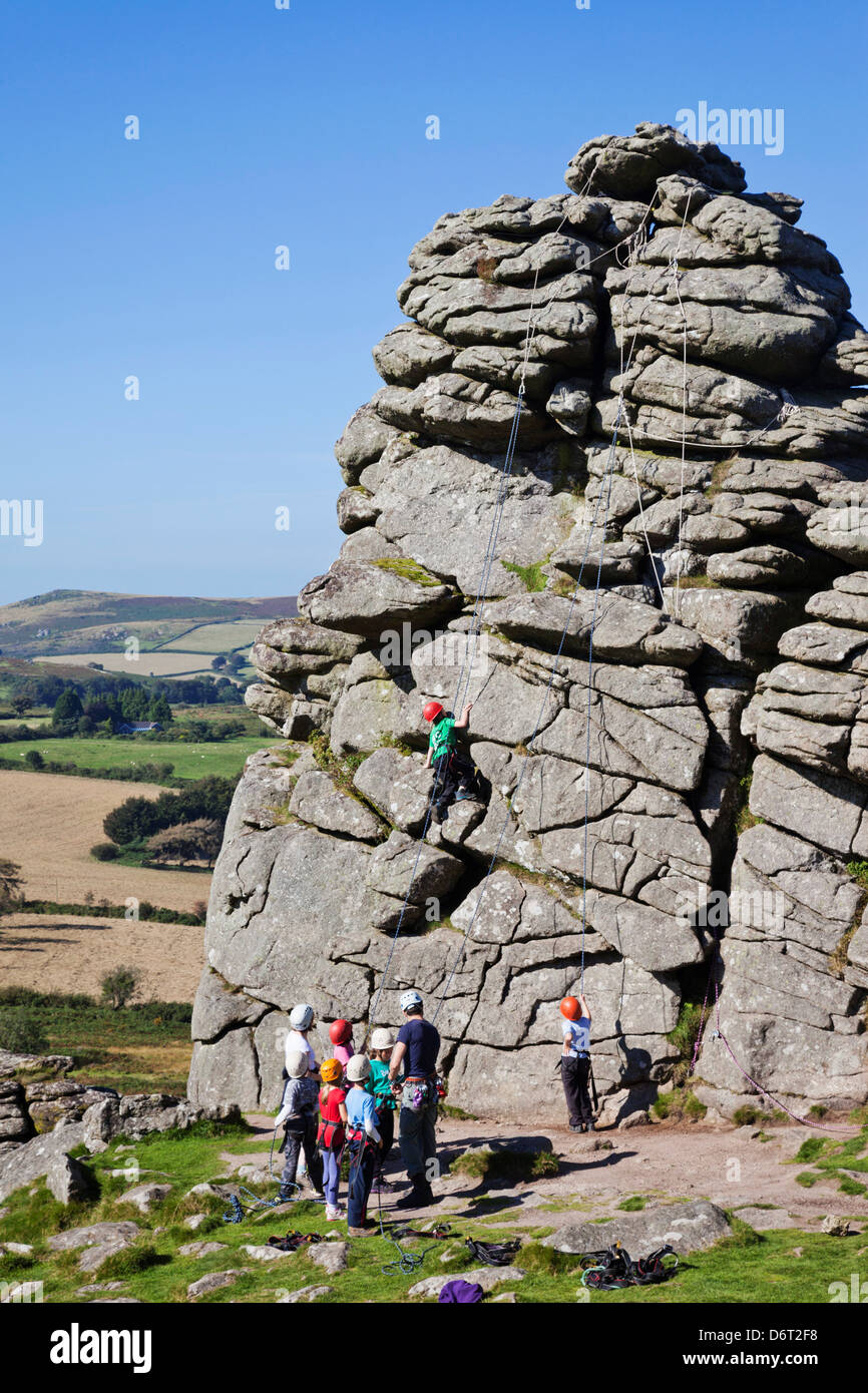 UK, England, Devon, Dartmoor, School Children Climbing Hound Tor Stock