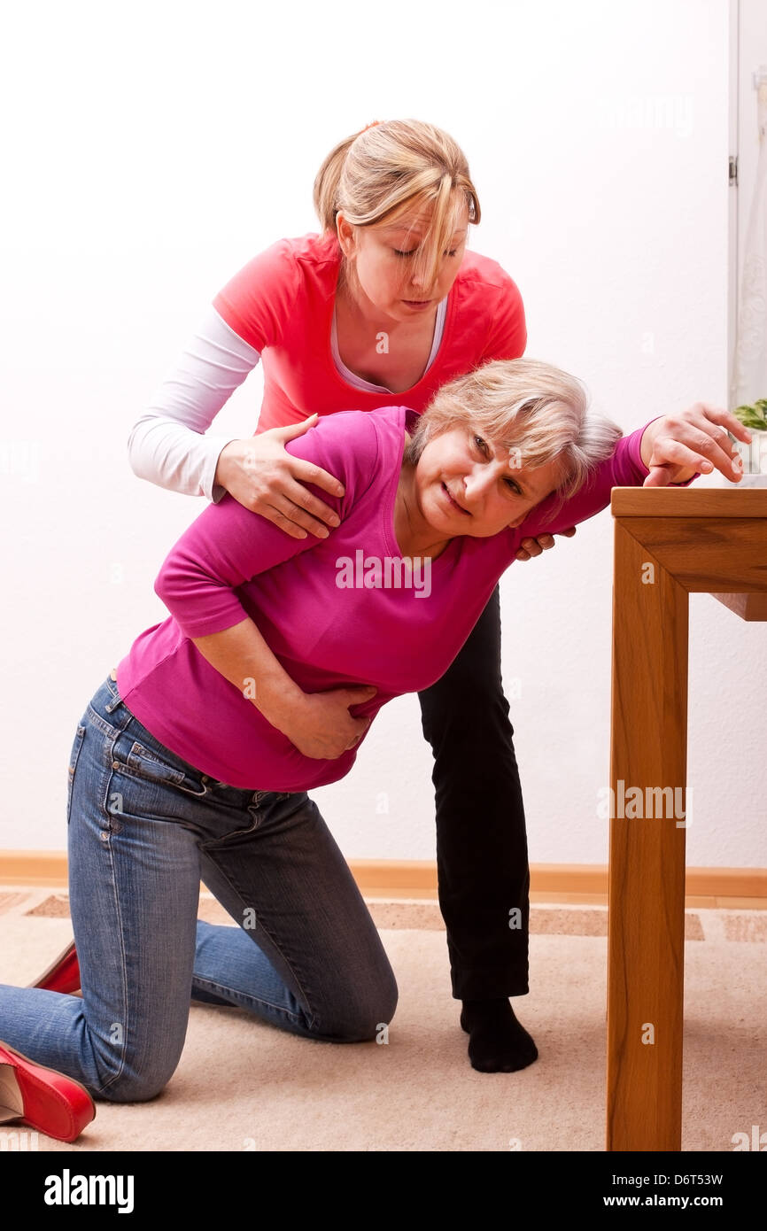 female senior collapses indoors Stock Photo