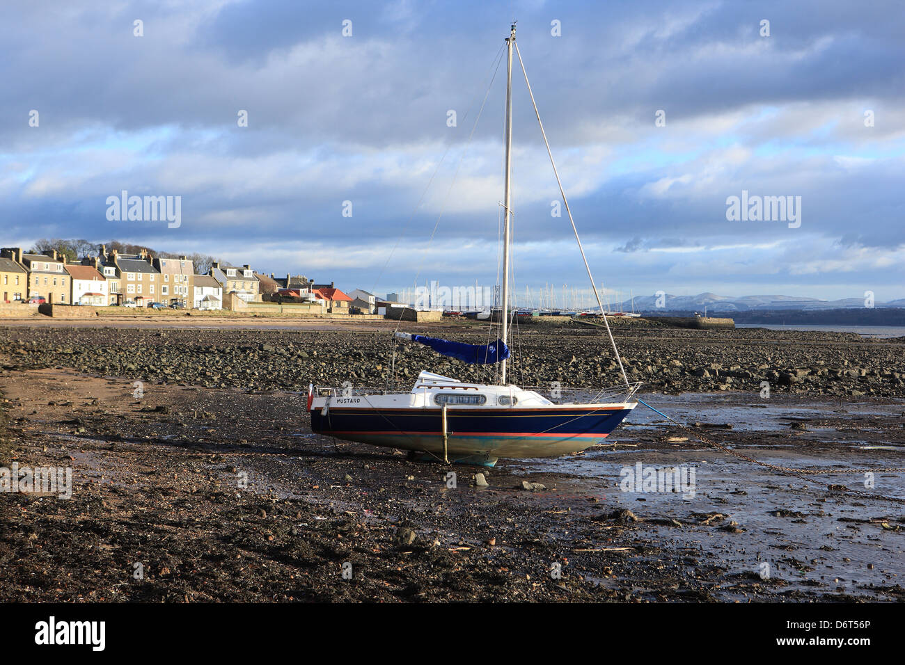 Yacht at low tide in the Fife coastal village of Limekilns in Scotland Stock Photo