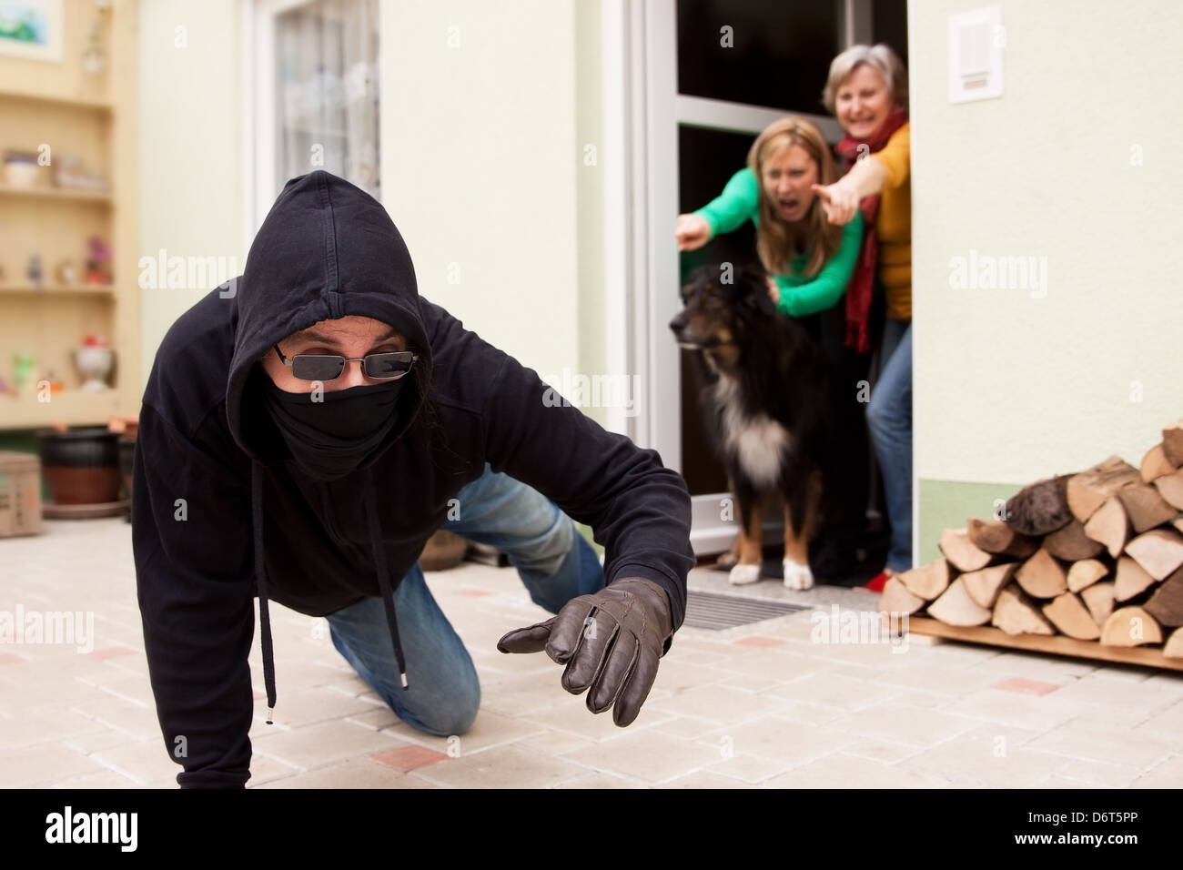 Scarpering Burglars trys to flee from the crime scene Stock Photo - Alamy