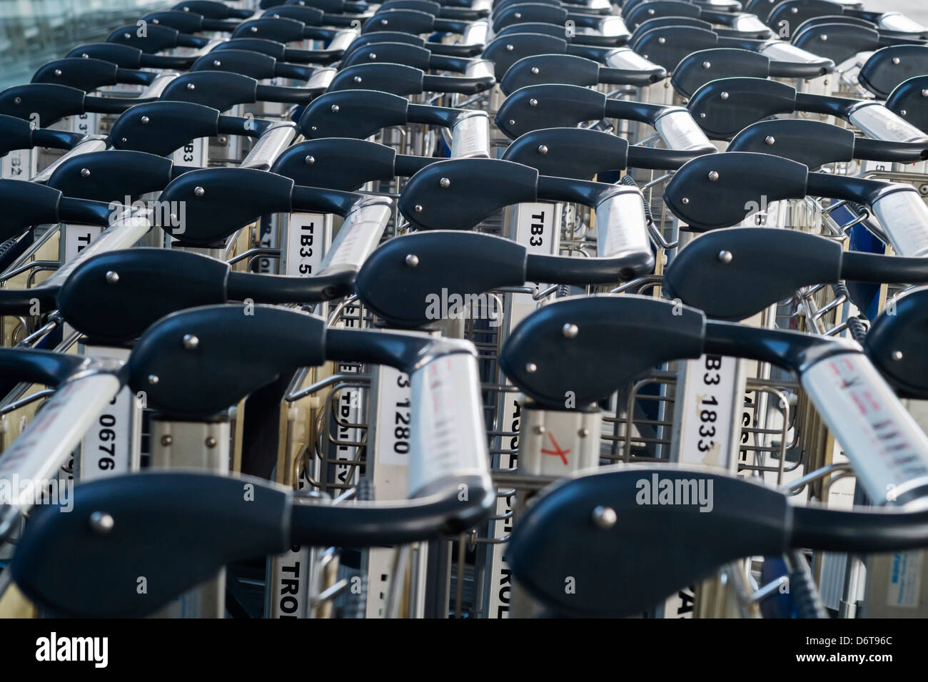 Many luggage trolleys lined up at an airport Stock Photo