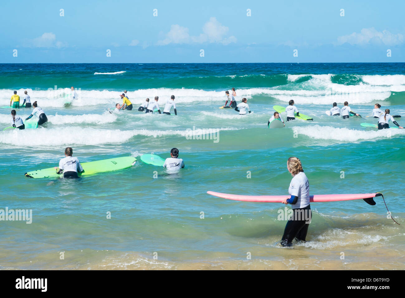 Busy surfing school in the sea at Manly Beach in Australia Stock Photo