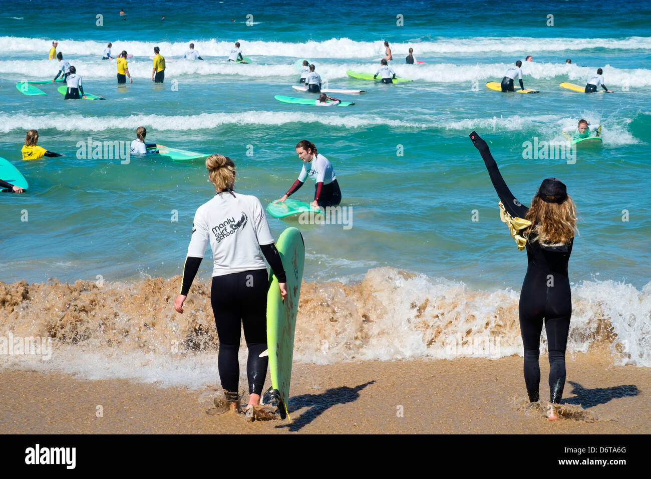 Busy surfing school in the sea at Manly Beach in Australia Stock Photo