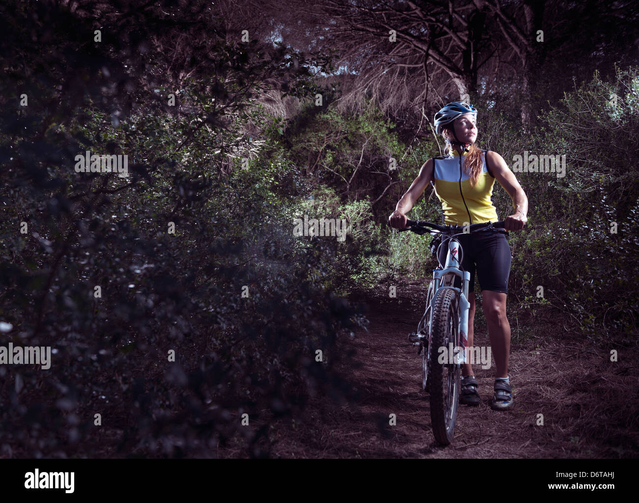 Woman lost in the forest on her mountain bike. Tarifa, Costa de la Luz, Cadiz, Andalusia, Spain, Europe. Stock Photo