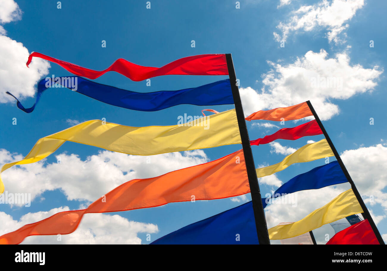 colorful bunting flags against a blue saturated sky with clouds Stock ...