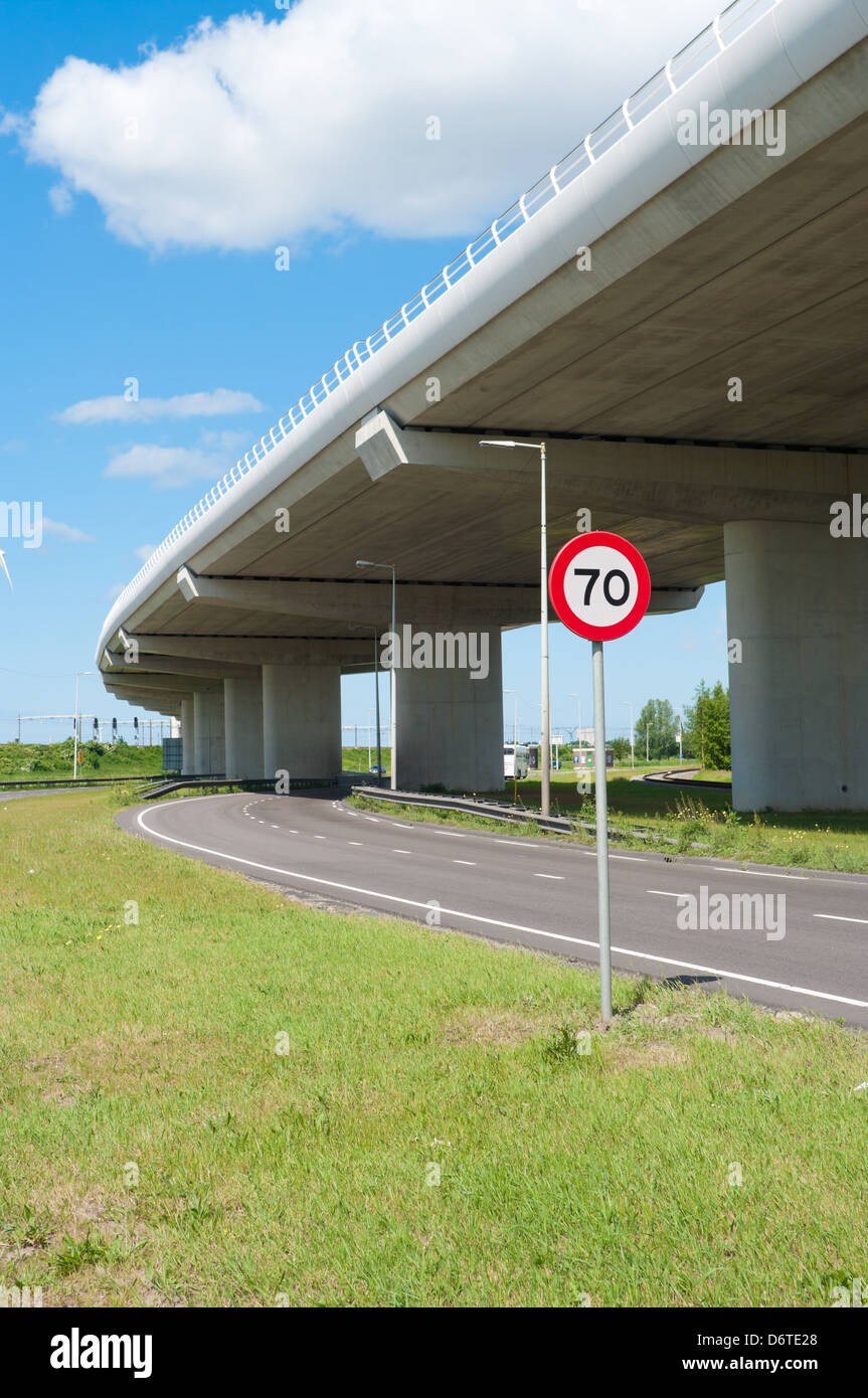 highway viaduct with speed limit traffic shield under it Stock Photo