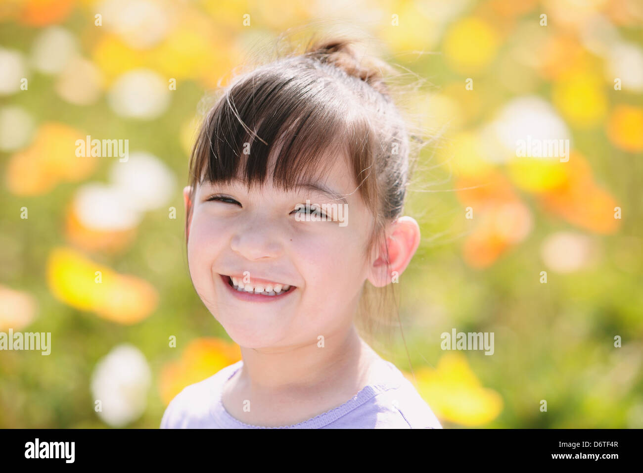 Young girl smiling at camera Stock Photo - Alamy