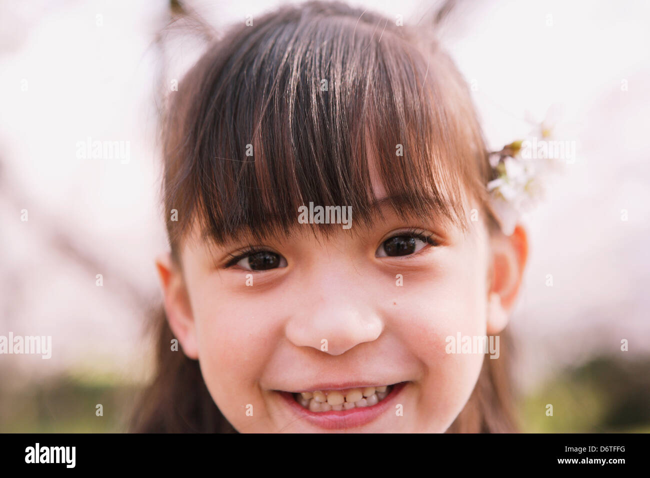 Young girl smiling at camera Stock Photo - Alamy