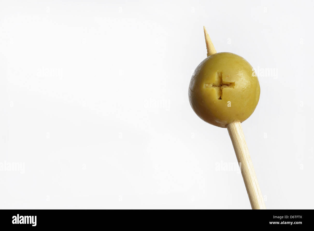 pitted green olive on wooden stick Stock Photo