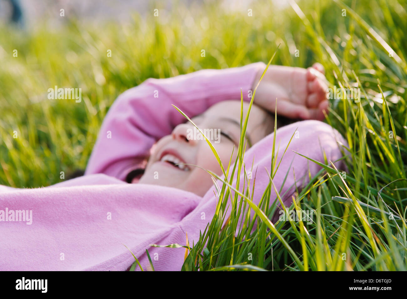 Young girl smiling on grassland Stock Photo - Alamy