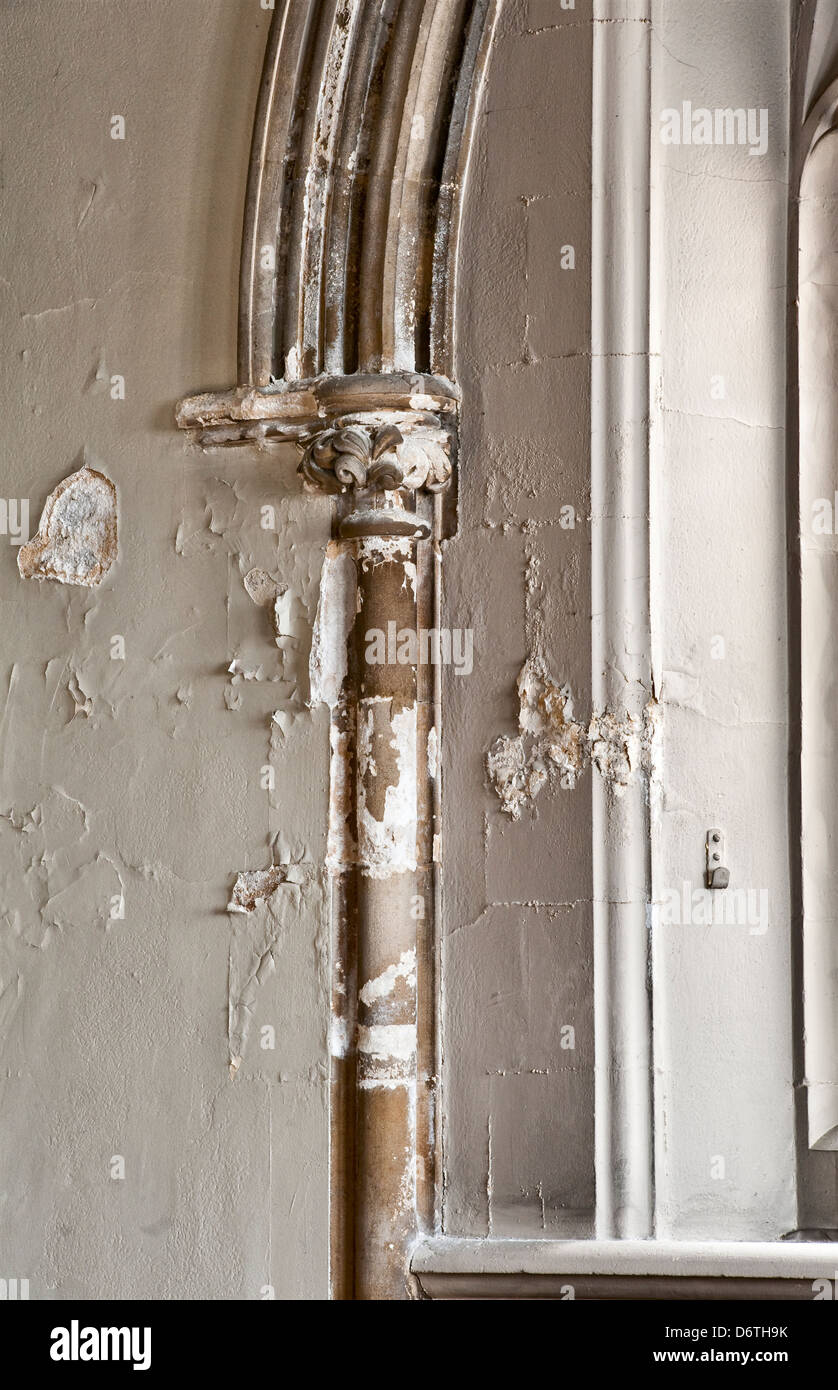 Damaged and rotting plaster in a Victorian church caused by water penetration from a leaking gutter (UK) Stock Photo