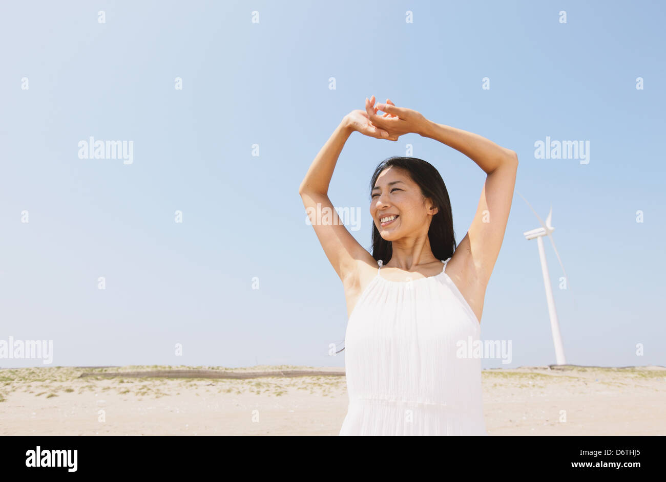 Woman in a white dress smiling away Stock Photo - Alamy