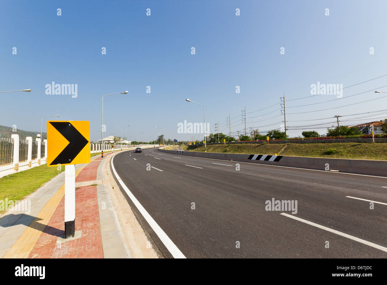 Road Sign warns Drivers to Beware Ahead Dangerous Curve. Stock Photo