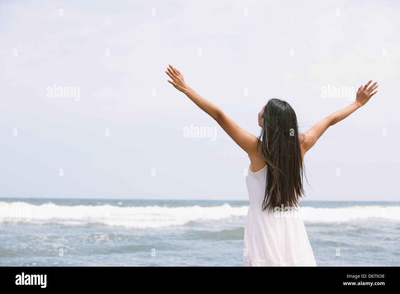 Woman in a white dress on the beach Stock Photo - Alamy