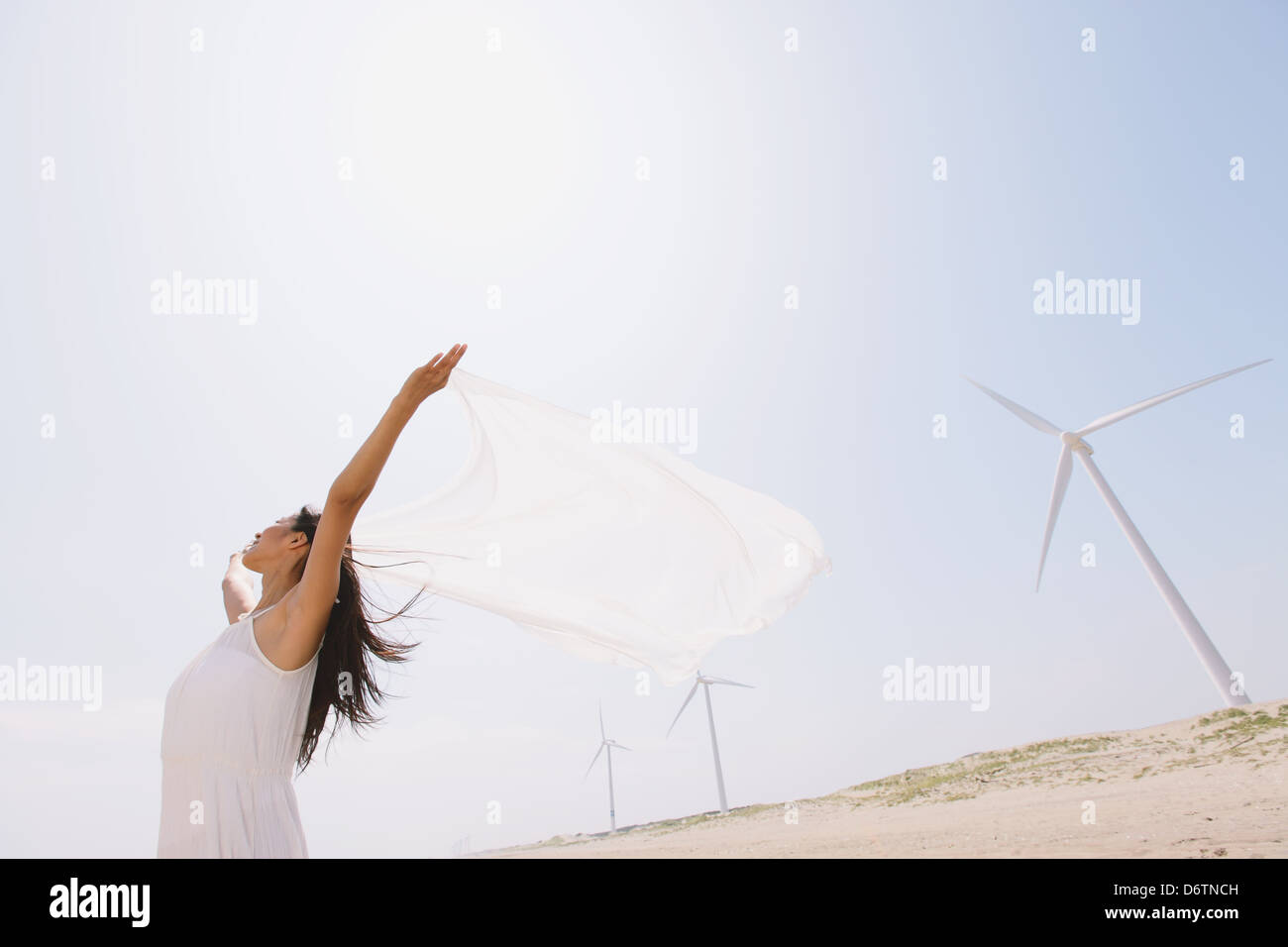 Woman in a white dress with white cloth on the beach Stock Photo - Alamy