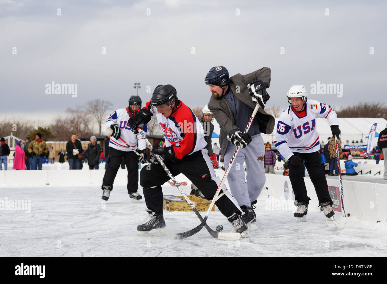 Teams compete at the U.S. Pond Hockey Championships on Lake Nokomis on January 19, 2013 in Minneapolis, Minnesota. Stock Photo