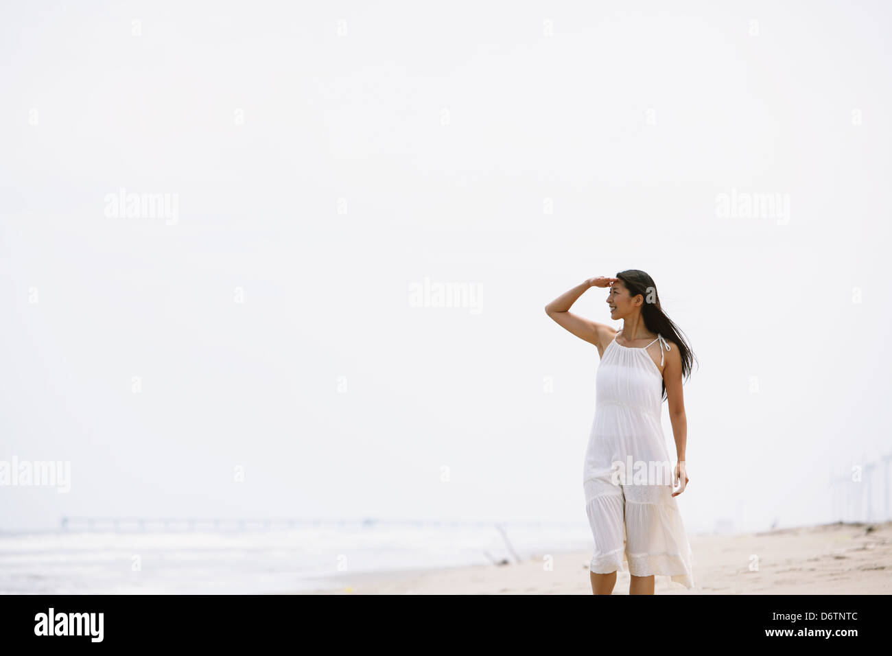 Woman in a white dress on the beach Stock Photo - Alamy