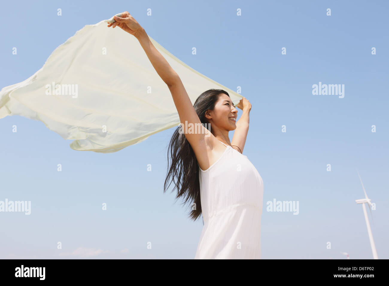 Woman in a white dress with white cloth on the beach Stock Photo - Alamy