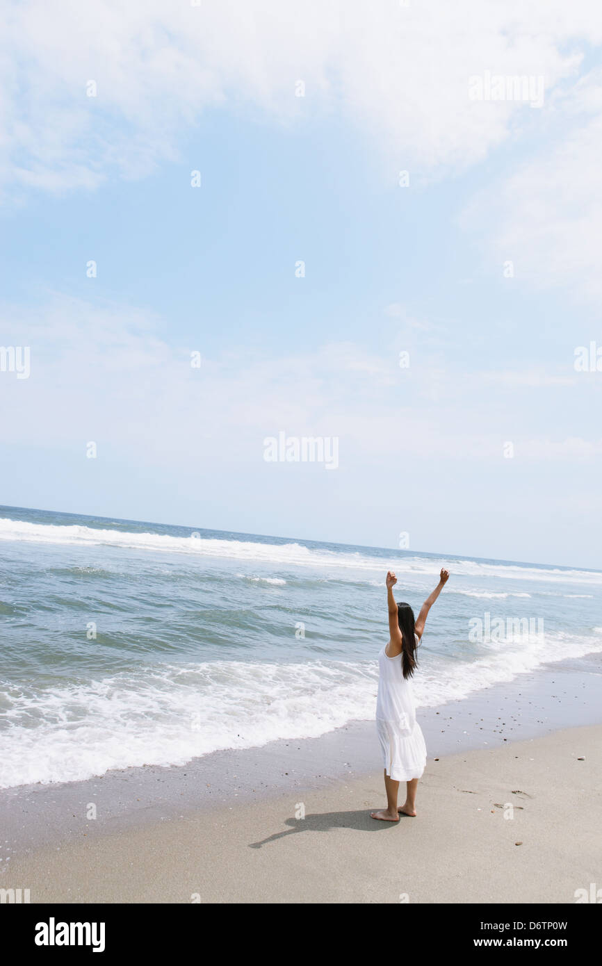 Woman in a white dress on the beach Stock Photo - Alamy