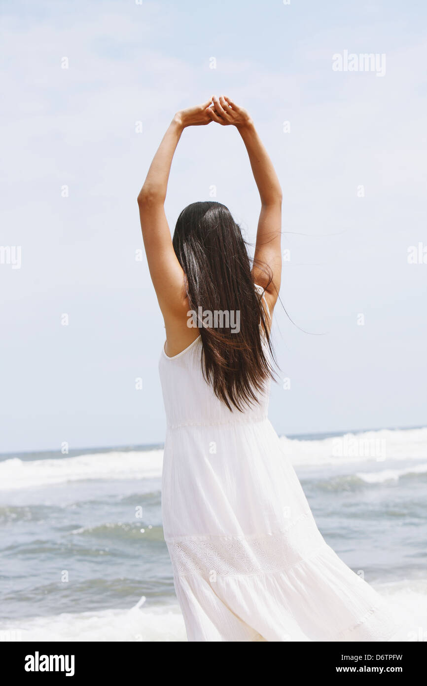 Woman in a white dress on the beach Stock Photo - Alamy