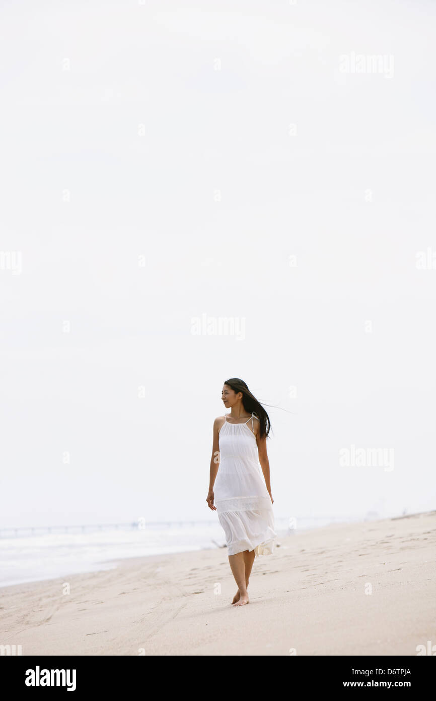 Woman in a white dress on the beach Stock Photo - Alamy