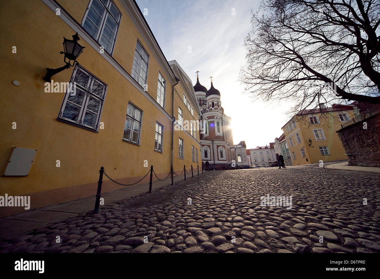 Insight into a narrow street with cobblestones at dusk in the Estonian capital Tallinn. Stock Photo