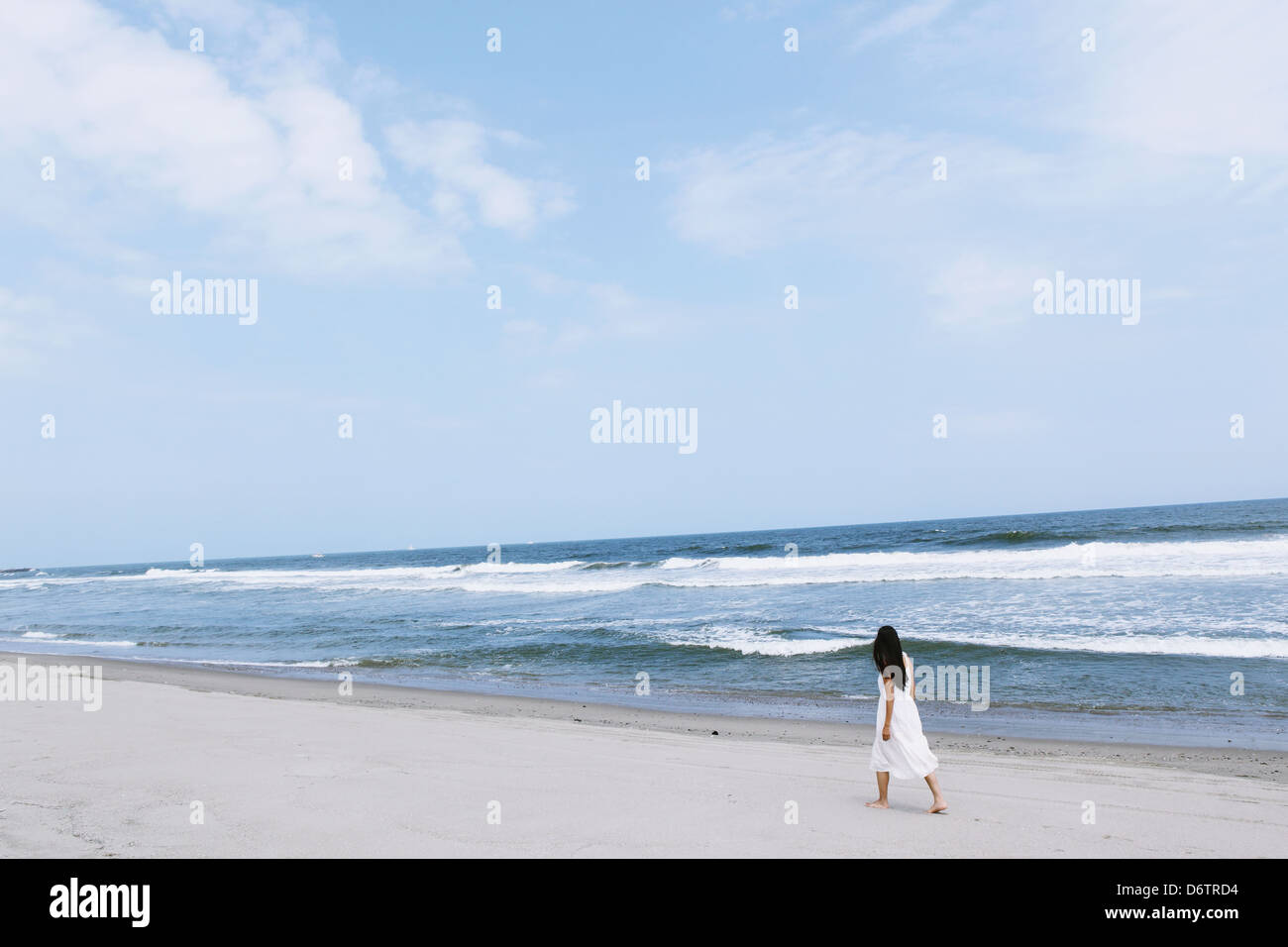 Woman in a white dress on the beach Stock Photo - Alamy