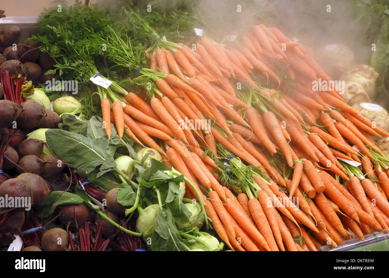 Vegetables kept fresh and cool with CO2 from dry ice, in a supermarket. Stock Photo