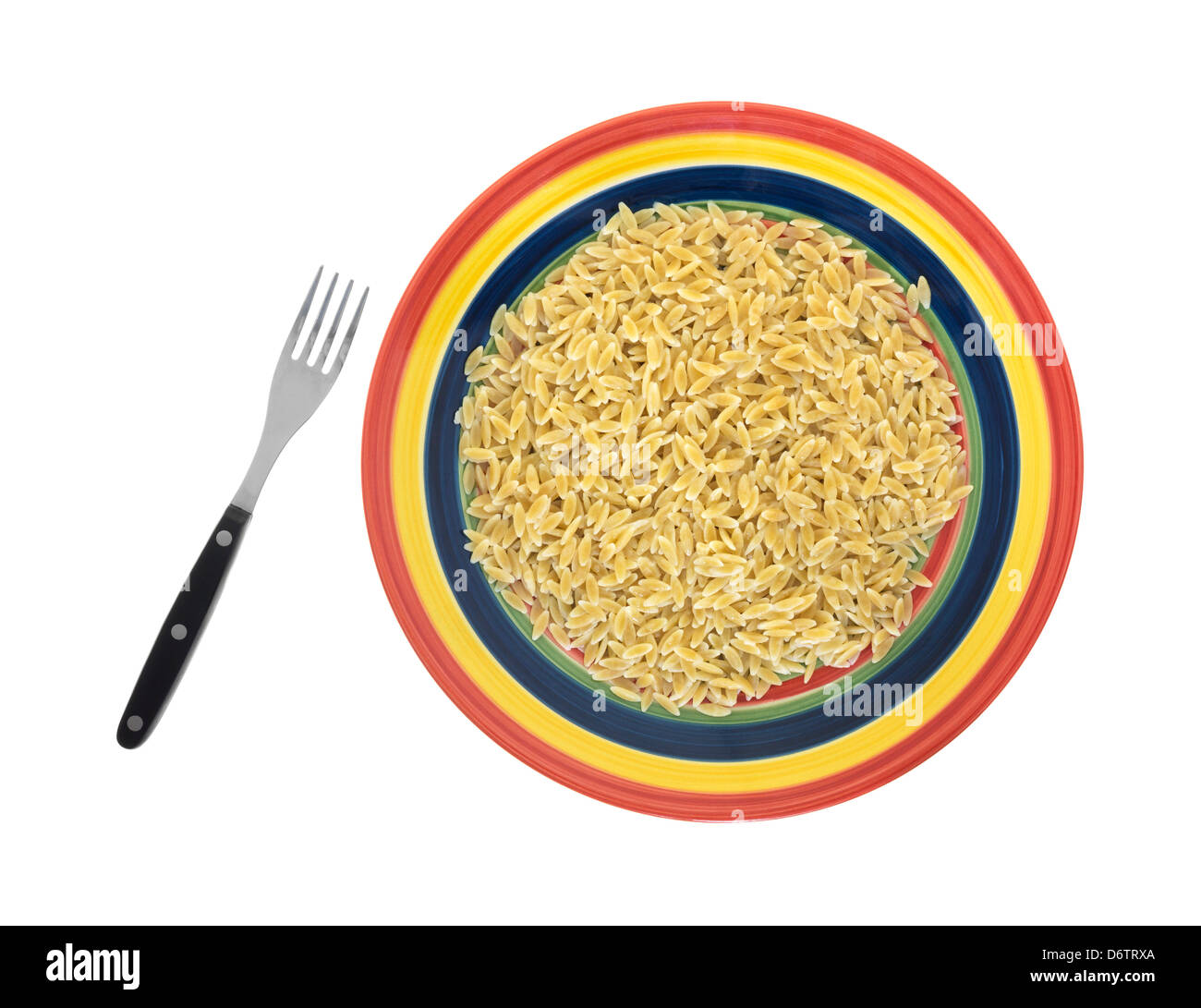 Top view of colorful plate with serving of cooked orzo pasta with fork on white background. Stock Photo