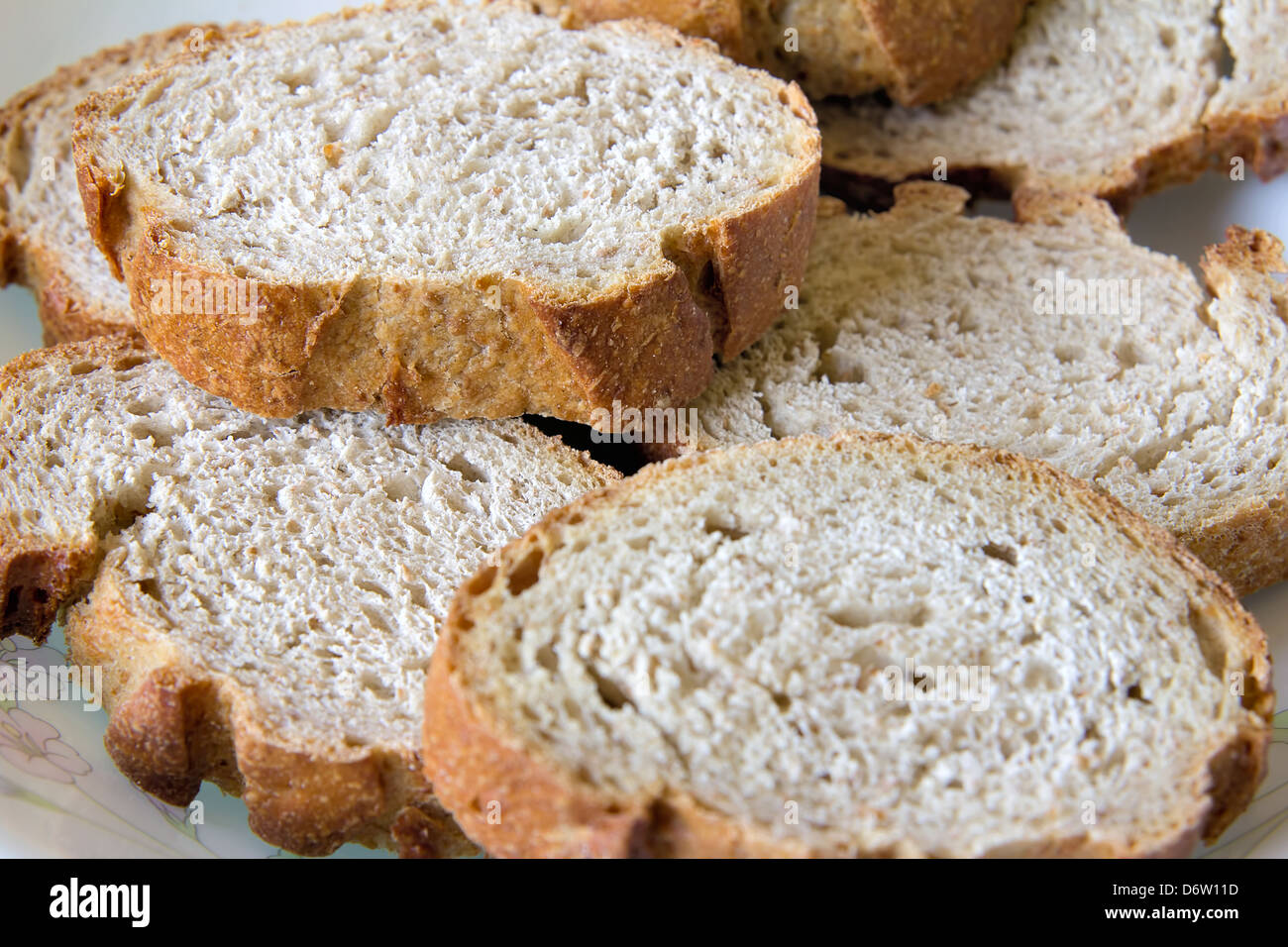 Sliced Sour Dough Whole Wheat French Bread on a Plate Closeup Stock Photo