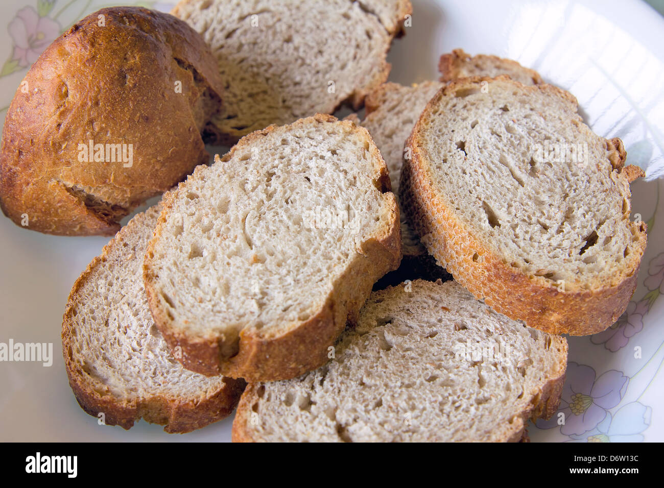 Sliced Sour Dough Whole Wheat French Bread on a Plate Stock Photo