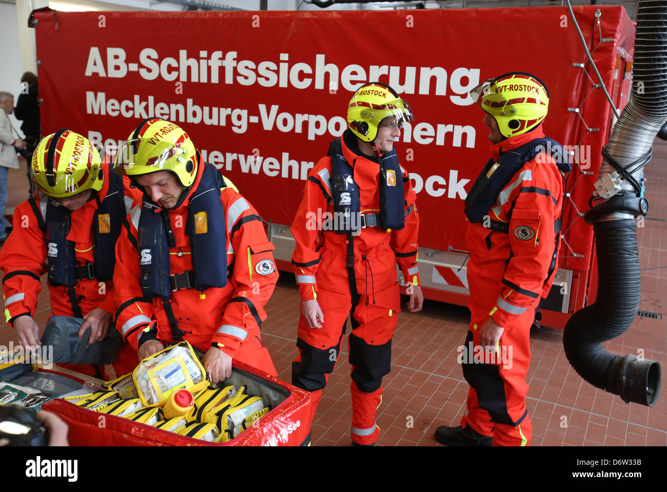 The future medical care team (VVT) of the Command for Maritime Emergencies (Havariekommando) if the fire department is introduced in Rostock, Germany, 23 April 2013. The team (L-R) paramedic Marcel Przybyla, doctor Martin Gloger, doctor Svend Kamysek, doctor Goetz Klaunick will officially start work on 01 May 2013. The VVT is one of ten team of the Havariekommandos along the German coast. The provide emergency medical care during serious ship accidents. Photo: Bernd Wuestneck Stock Photo