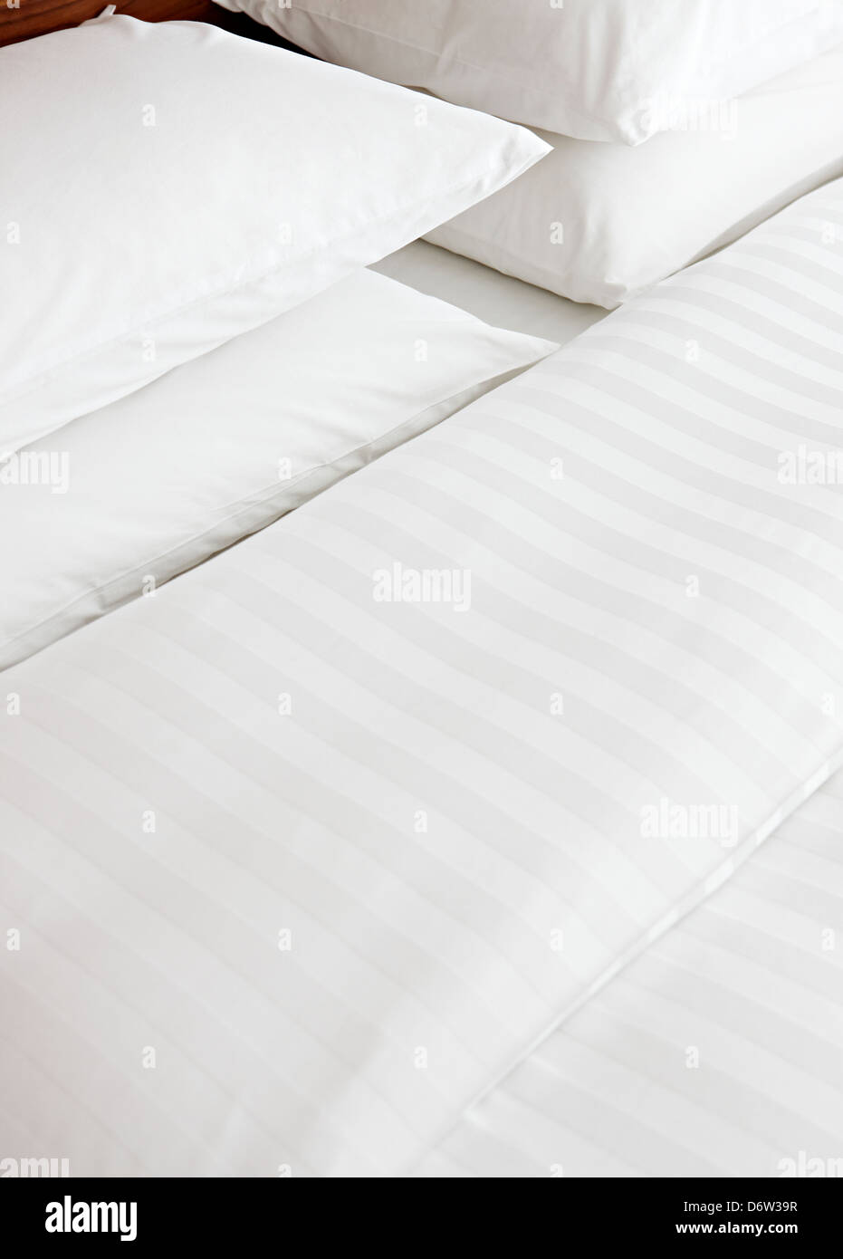 crisp white strip cotton bedding detail Stock Photo