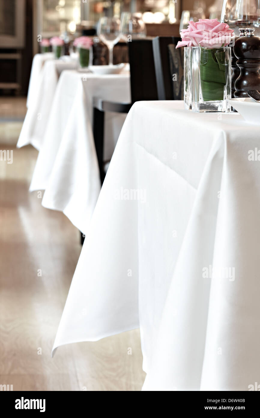 line of white dining table cloths restaurant Stock Photo