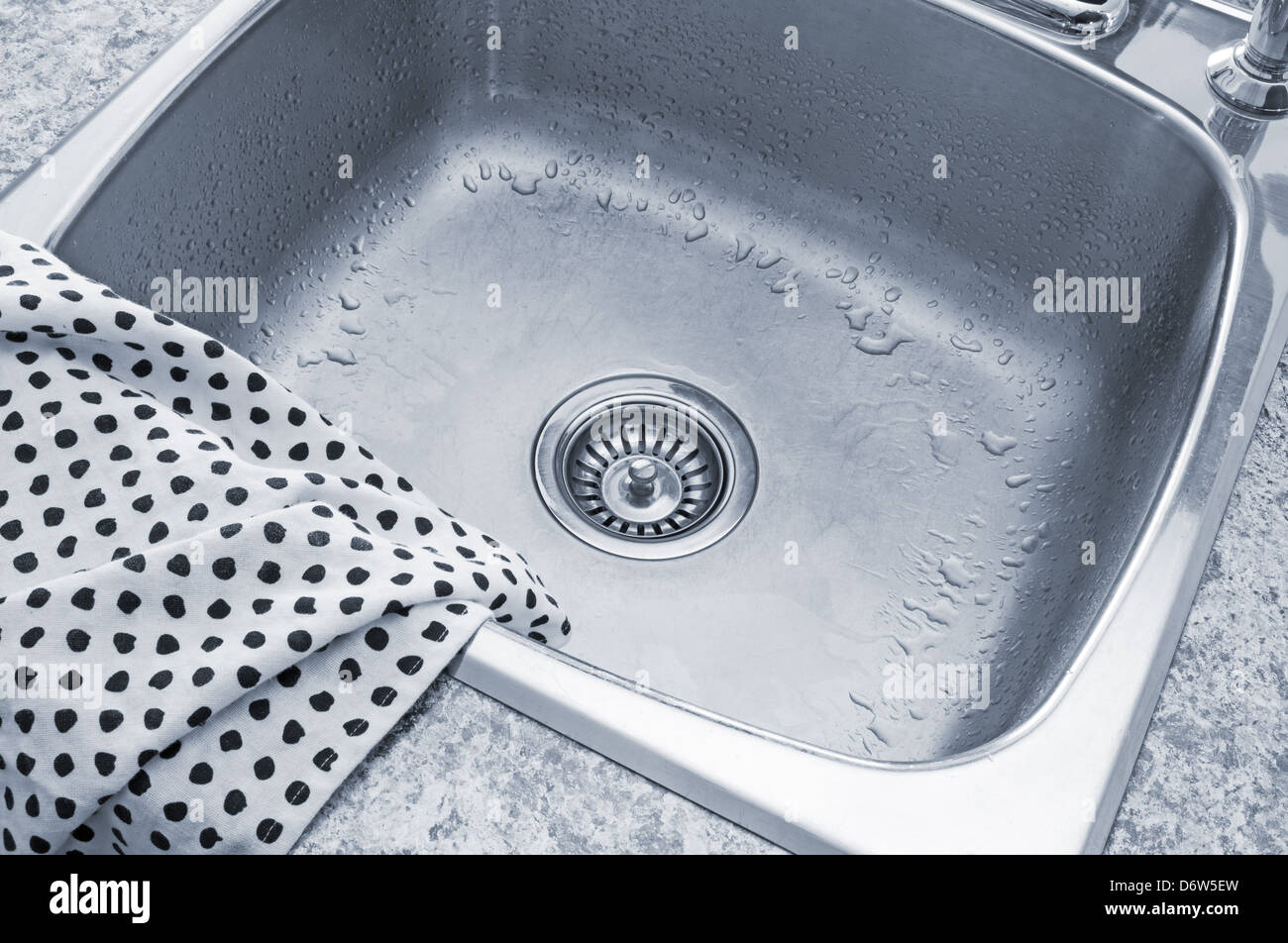 Clean metal sink and polka dot kitchen towel Stock Photo Alamy