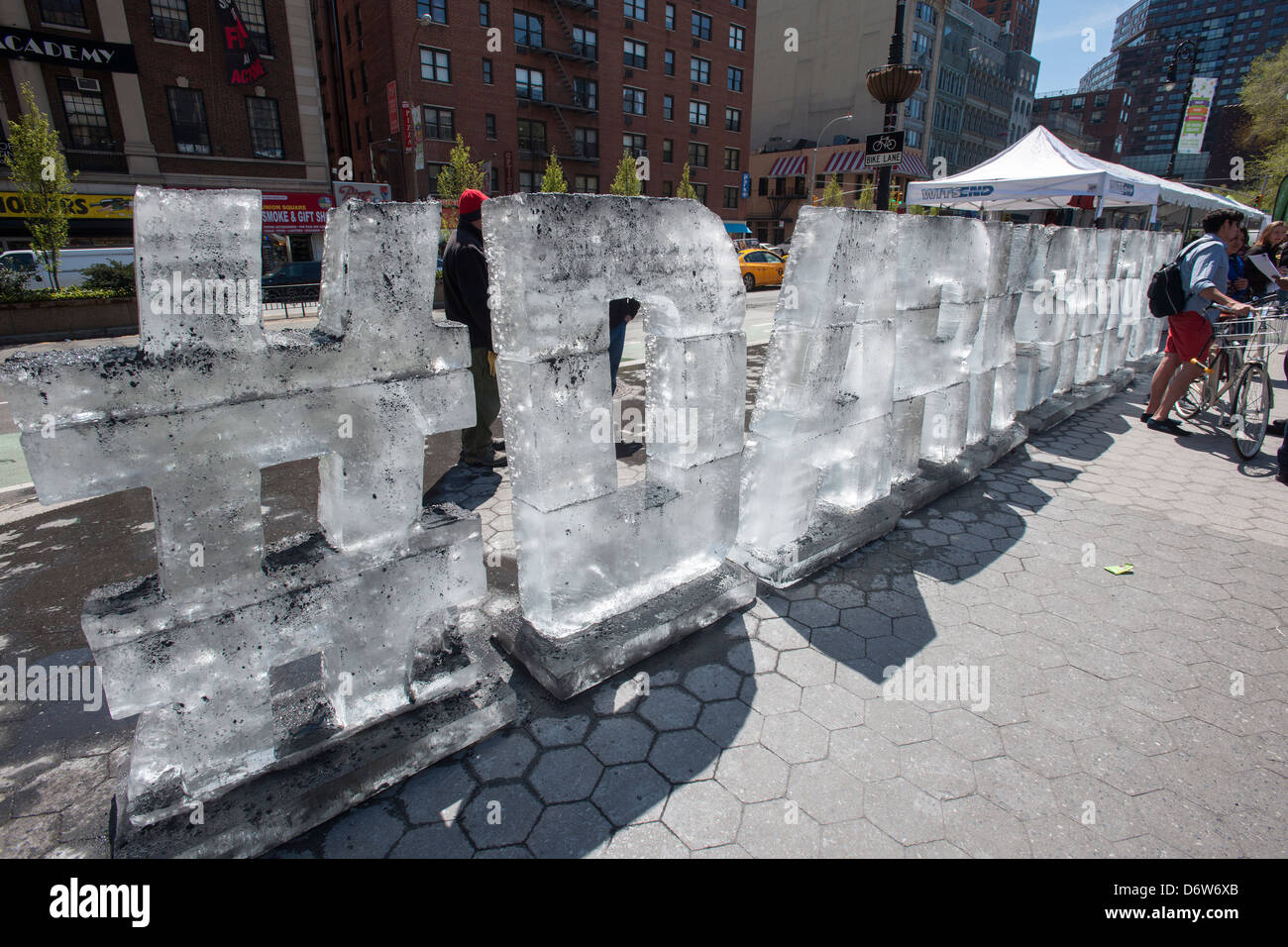 An ice sculpture by the Dark Snow Project covered in soot is seen at an Earth Day fair in Union Square Park in New York Stock Photo