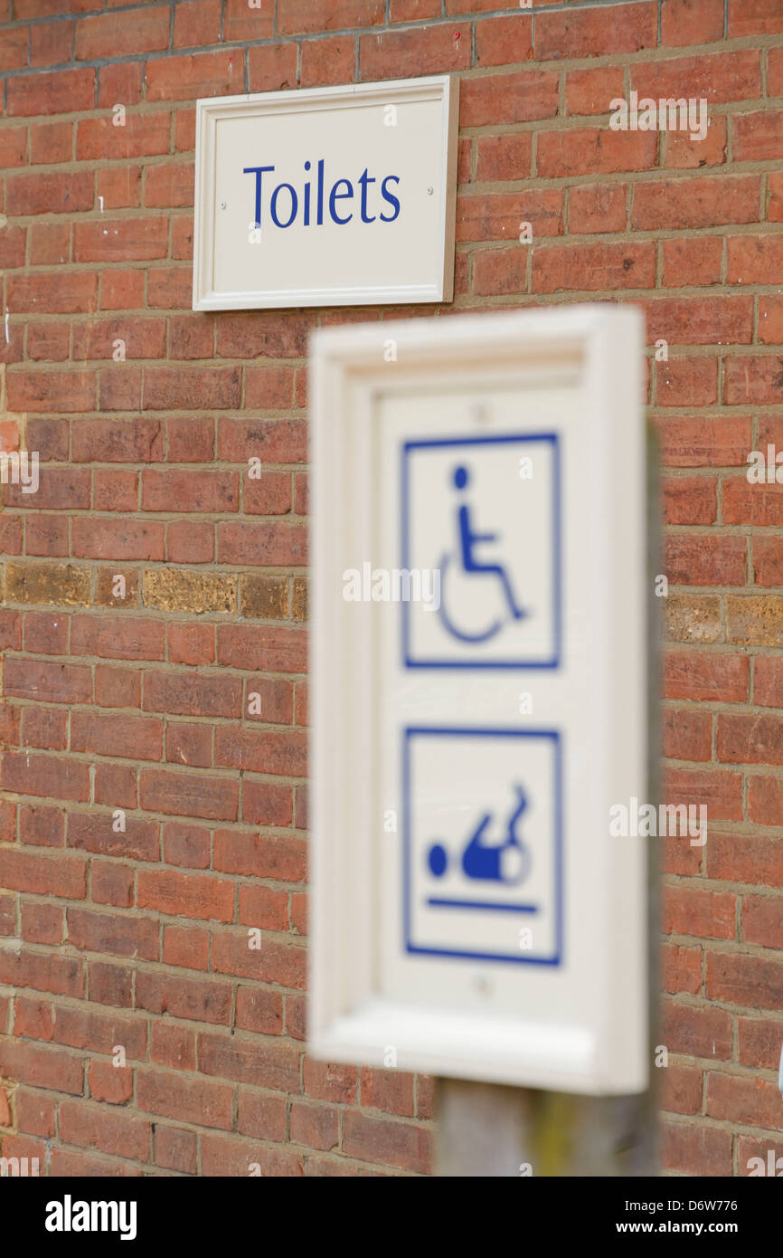 A disabled handicapped baby change changing room toilet toilets wooden timber sign notice Stock Photo
