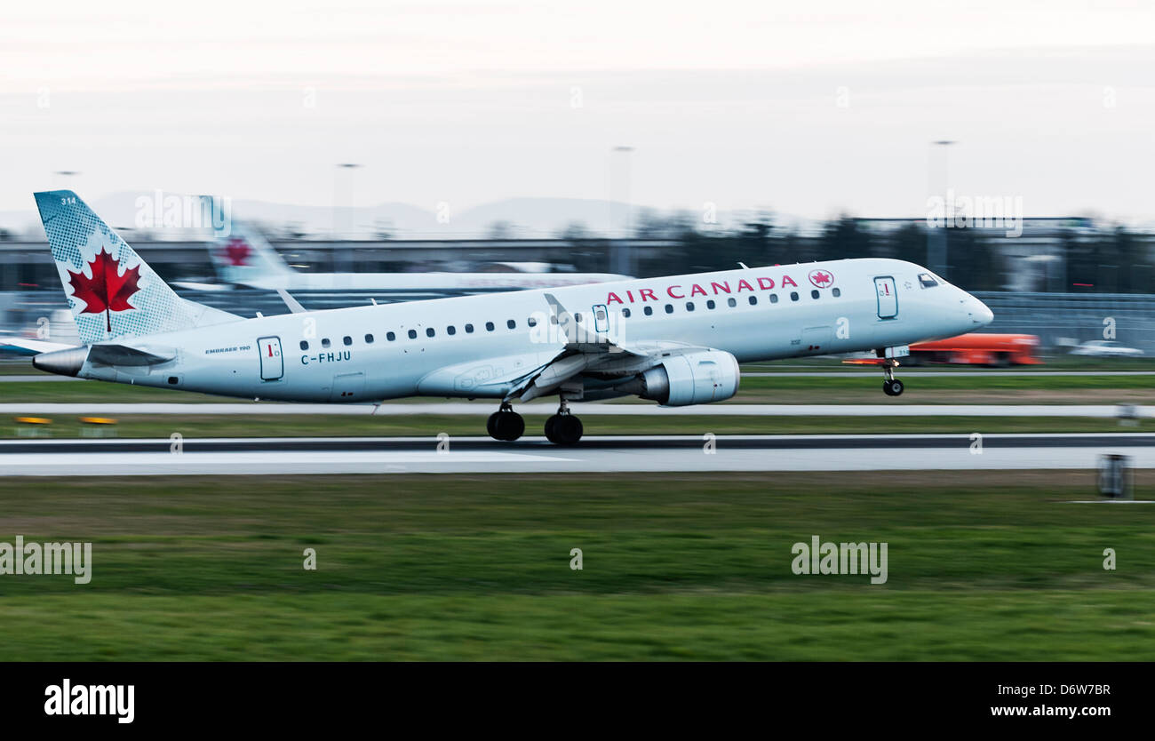 An Air Canada Embraer ERJ-190 jetliner lands at Vancouver International Airport. Stock Photo