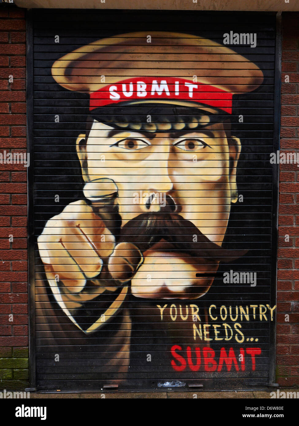 Your country needs...Submit. Shop advert in Manchester UK Stock Photo